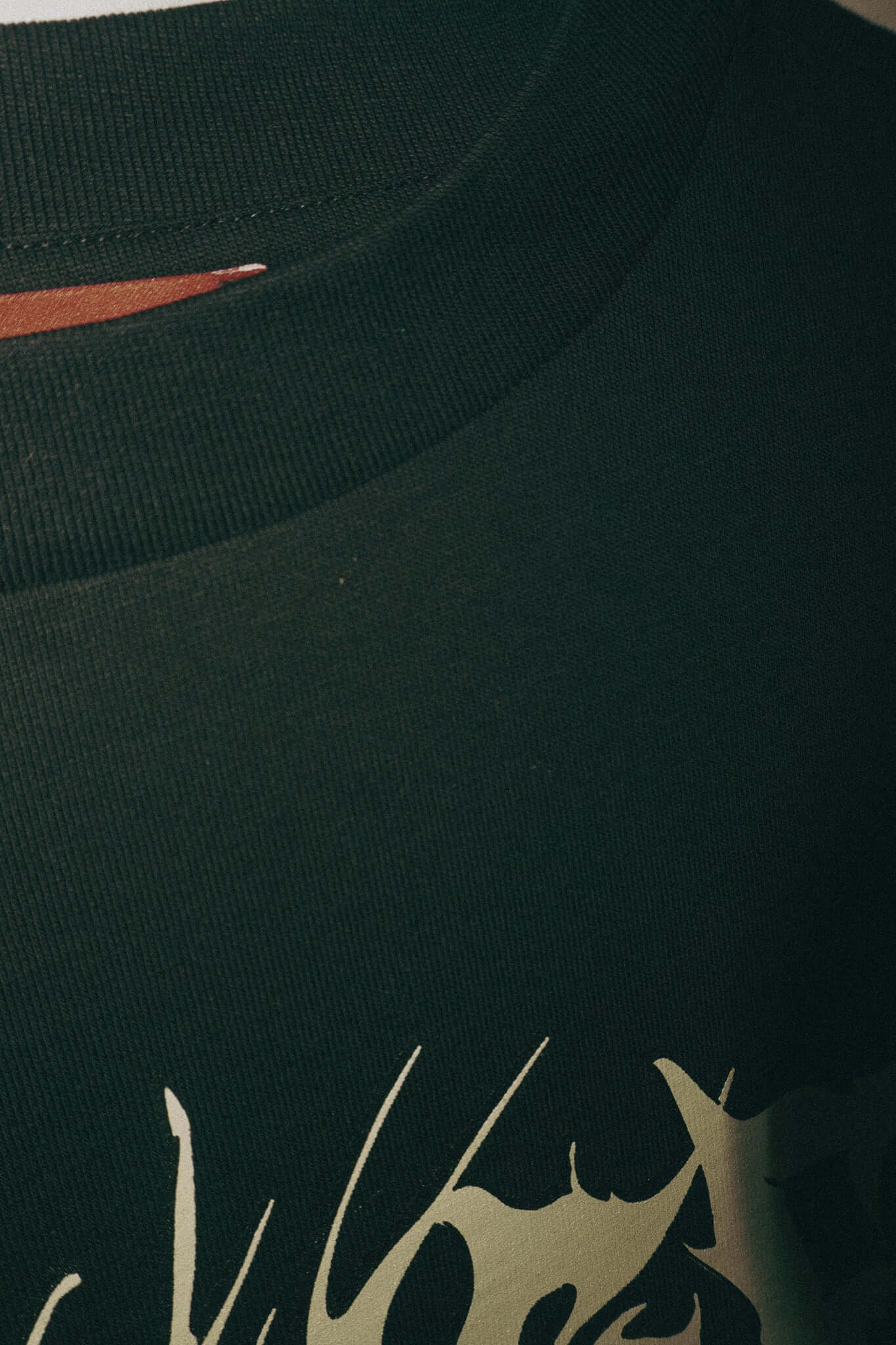 Detail of double sleeve black T-shirt with unique screen print design, made of 100% cotton, Jersey fabric.