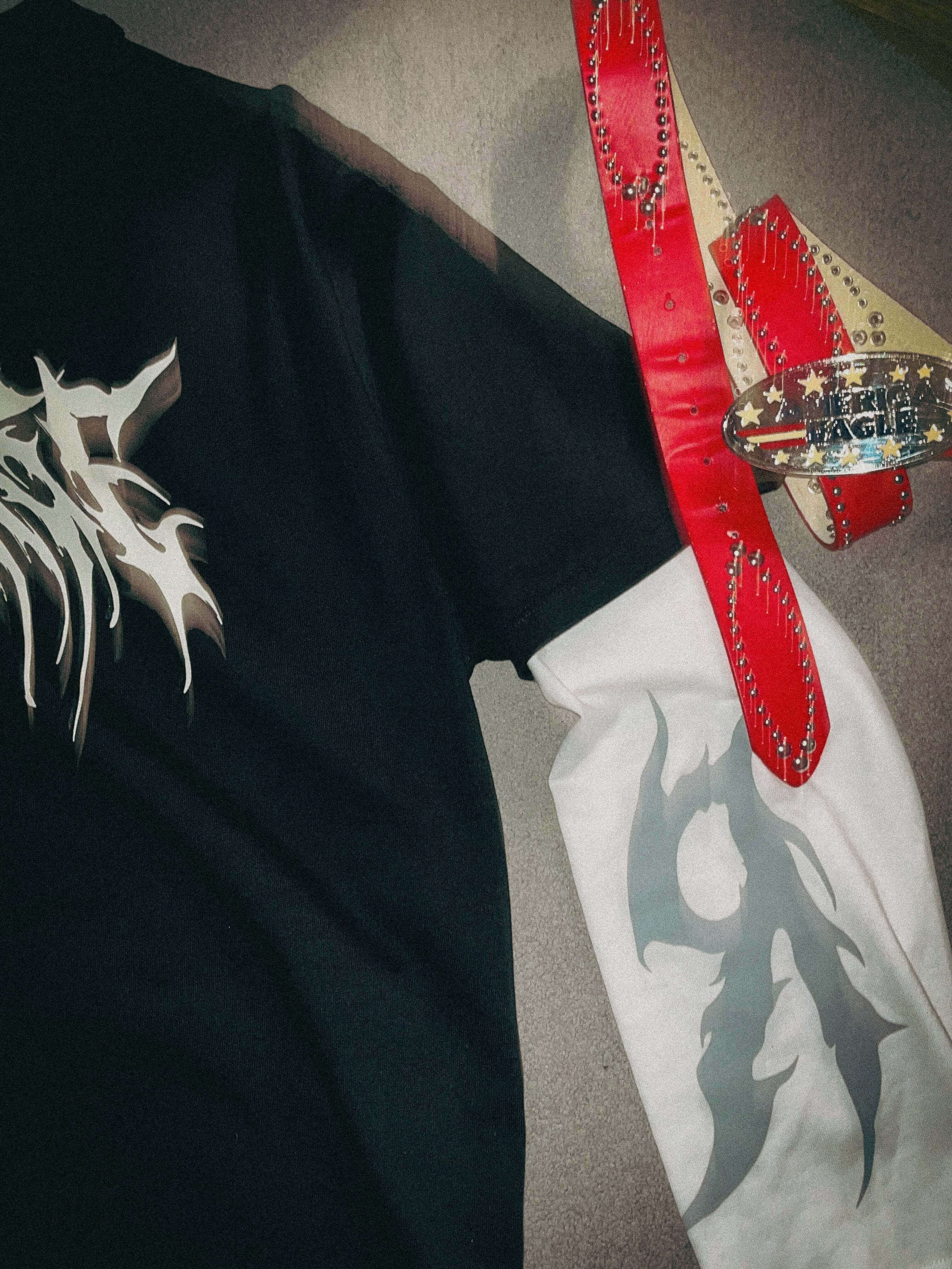 Double sleeve distorted graphic t-shirt with a championship belt, showcasing unique design elements.